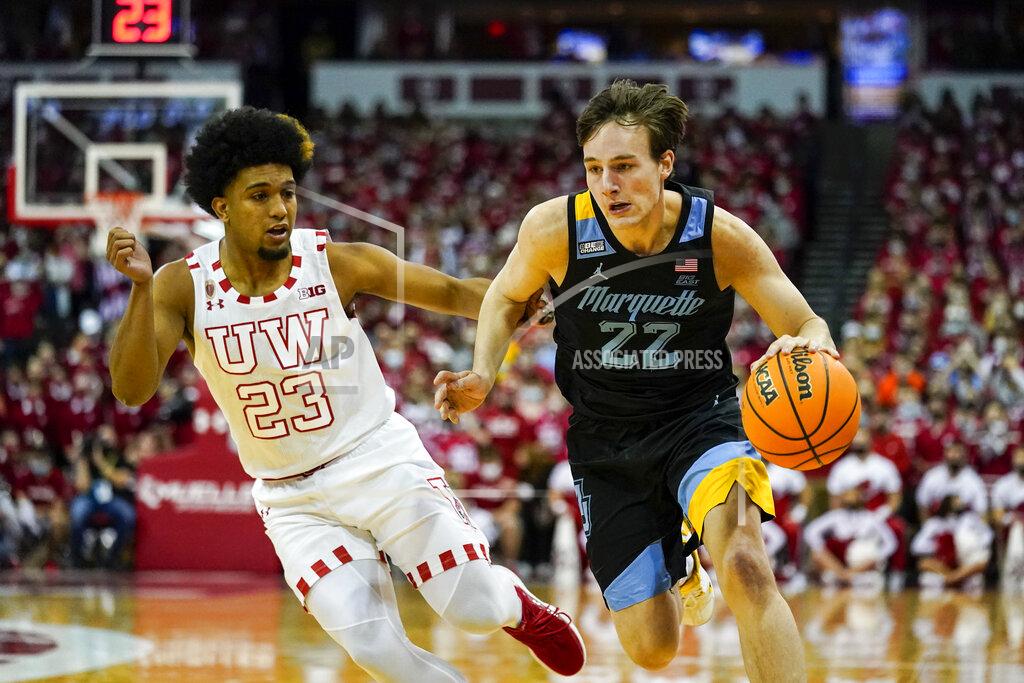 Andy Manis Marquette's Tyler Kolek (22) drives against Wisconsin's Chucky Hepburn (23) during the first half of an NCAA college basketball game Saturday, Dec. 4, 2021, in Madison, Wis. (AP Photo/Andy Manis)