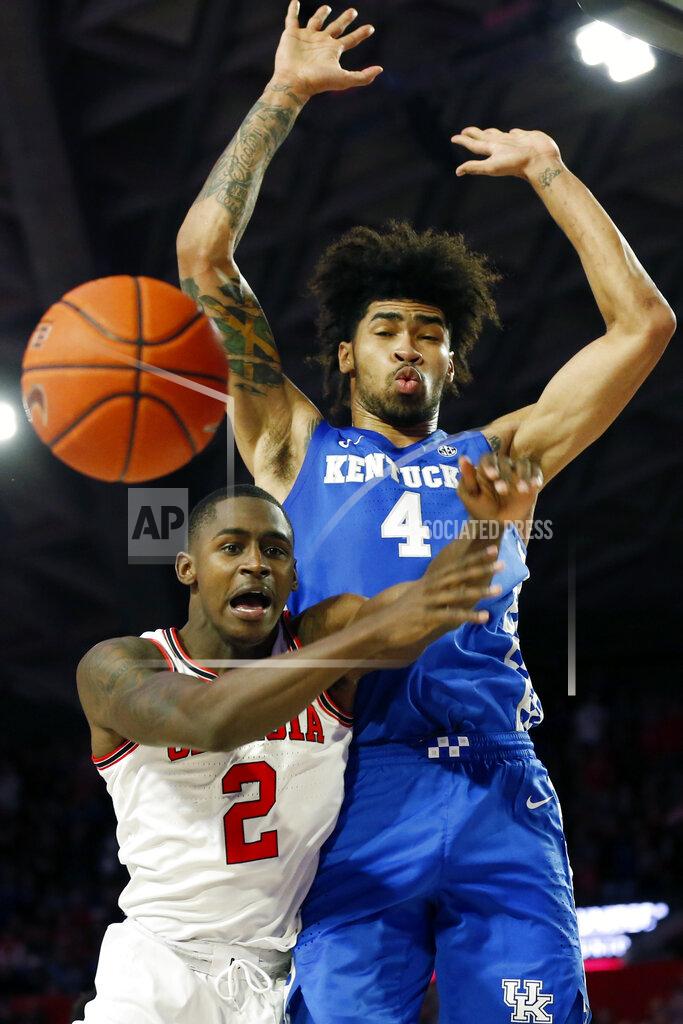 Joshua L. Jones Georgia's Jordan Harris (2) loses the ball while being defended by Kentucky forward Nick Richards (4) during an NCAA college basketball game Tuesday, Jan. 7, 2020, in Athens, Ga. Kentucky won 78-69. (Joshua L. Jones/Athens Banner-Herald via AP)
