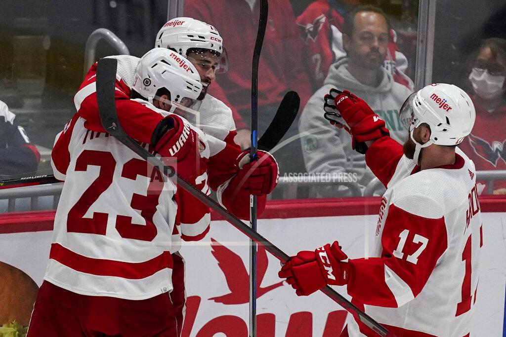 Alex Brandon Detroit Red Wings right wing Lucas Raymond (23), center Dylan Larkin (71) and defenseman Filip Hronek (17) celebrate the game-wining goal by Larkin after an NHL hockey game against the Washington Capitals, Wednesday, Oct. 27, 2021, in Washington. The Red Wings won 3-2 in overtime. (AP Photo/Alex Brandon)