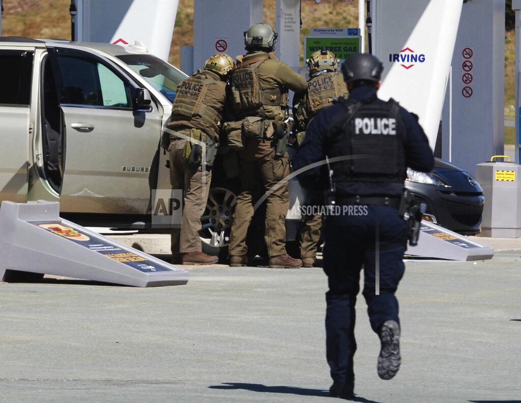 Tim Krochak Royal Canadian Mounted Police officers surround a suspect at a gas station in Enfield, Nova Scotia on Sunday April 19, 2020. Canadian police say multiple people are dead plus the suspect after a shooting rampage across the province of Nova Scotia. It was the deadliest shooting in Canada in 30 years. (Tim Krochak/The Canadian Press via AP)