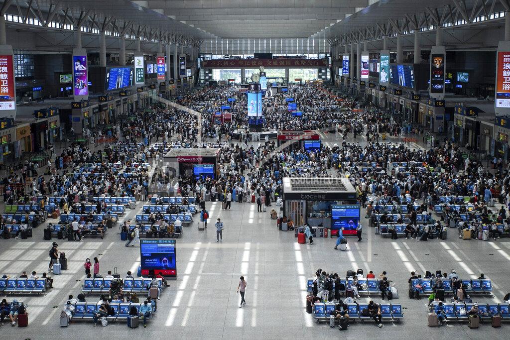 Uncredited Passengers wait for their train at the Hongqiao Railway Station in Shanghai, China Sunday, May 22, 2022. The locked-down Chinese metropolis of Shanghai opens some public transit services as it slowly eases pandemic restrictions that have kept most residents in their housing complexes for more than six weeks. (Chinatopix via AP)