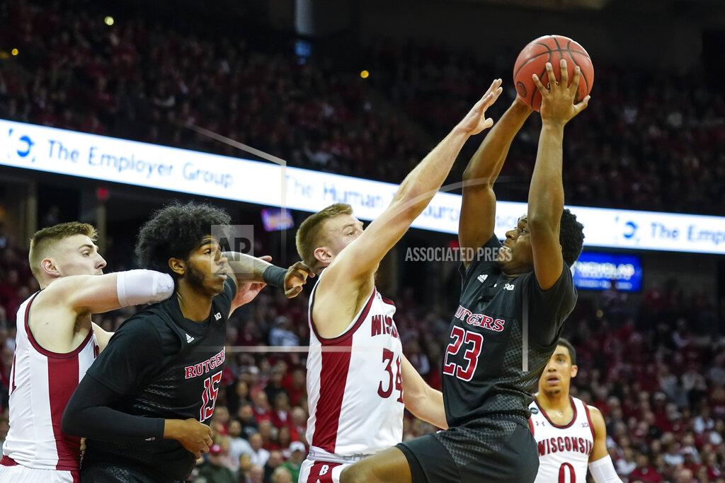 Andy Manis Rutgers' Montez Mathis (23) shoots against Wisconsin's Brad Davison (34) during the first half of an NCAA college basketball game Sunday, Feb. 23, 2020, in Madison, Wis. Wisconsin's Micah Potter, left, and Rutgers' Myles Johnson (15) look on. (AP Photo/Andy Manis)