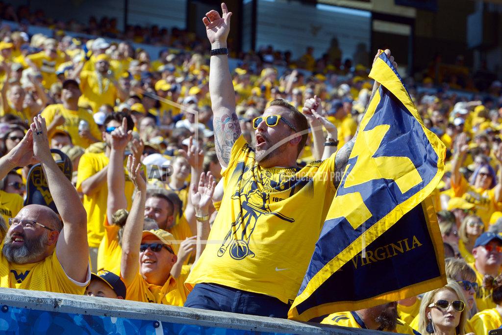 Craig Hudson West Virginia fans cheer during the first half of an NCAA college football game against Kansas in Morgantown, W. Va., Saturday Oct. 6, 2018. (Craig Hudson/Charleston Gazette-Mail via AP)