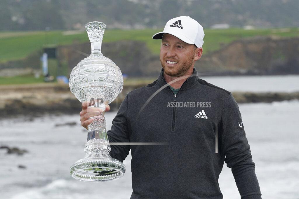 Eric Risberg Daniel Berger holds up his trophy on the 18th green of the Pebble Beach Golf Links after winning the AT&T Pebble Beach Pro-Am golf tournament Sunday, Feb. 14, 2021, in Pebble Beach, Calif. (AP Photo/Eric Risberg)