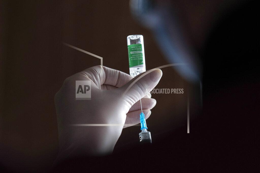 Evgeniy Maloletka A medic prepares to administer a dose of an AstraZeneca COVID-19 vaccine marketed under the name CoviShield, to a Ukrainian serviceman at a military base in Kramatorsk, Ukraine, Tuesday, March 2, 2021. Ukraine plans to vaccinate 14.4 million people this year, or about 35% of its 41 million people. (AP Photo/Evgeniy Maloletka)