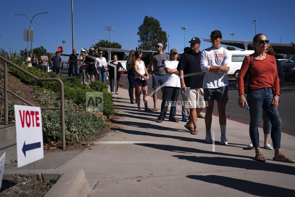 Jae C. Hong FILE - In this Sept. 14, 2021 file photo people wait in line outside a voting center to cast their recall ballots in Huntington Beach, Calif. California Republicans needed a heroic turnout in Tuesday's recall election to have any chance of ousting Democratic Gov. Gavin Newsom, but preliminary vote tallies, Friday Sept. 17, 2021, show overall turnout in the state was around 55%, far below the 80% that voted in the 2020 presidential contest. (AP Photo/Jae C. Hong, File)