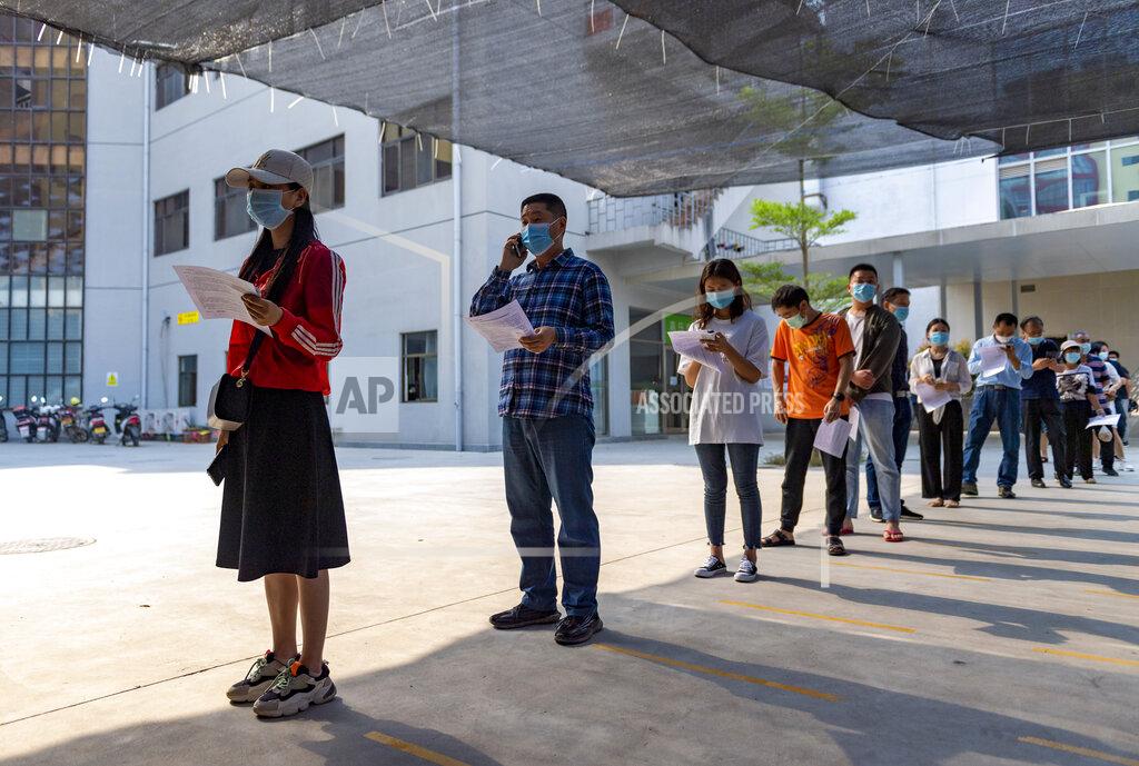 Chen Xinbo In this photo released by Xinhua News Agency, residents wearing masks line up for COVID-19 vaccination at the Jingcheng Hospital in Ruili city in southwestern China's Yunnan Province, April 1, 2021. The Chinese border city hit by a fresh outbreak of COVID-19 this week began a five-day drive Friday to vaccinate its entire population of 300,000 people. (Chen Xinbo/Xinhua via AP)