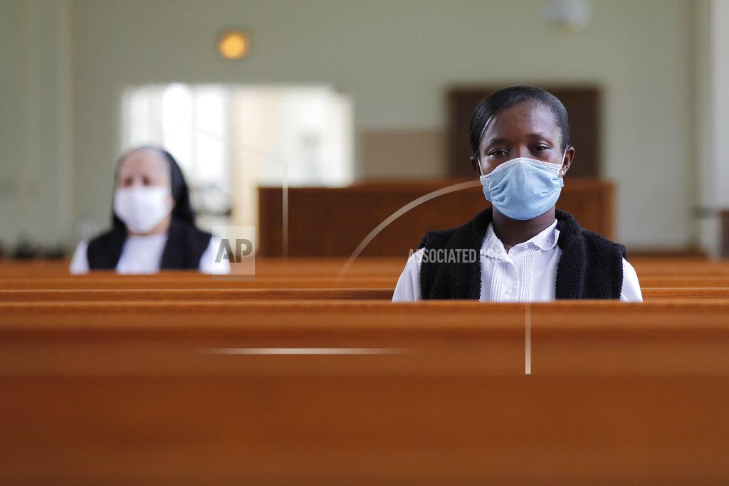 Gerald Herbert FILE - In this Thursday, July 23, 2020 file photo, Faustina Bema, a candidate for Novice of the Sisters of the Holy Family, prays inside a chapel during a retreat at their Mother House in New Orleans. In the archdioceses of New Orleans and Chicago, top leaders are encouraging their schools to place a new emphasis on teaching about racial justice, as well as the history of Black Catholics. (AP Photo/Gerald Herbert)
