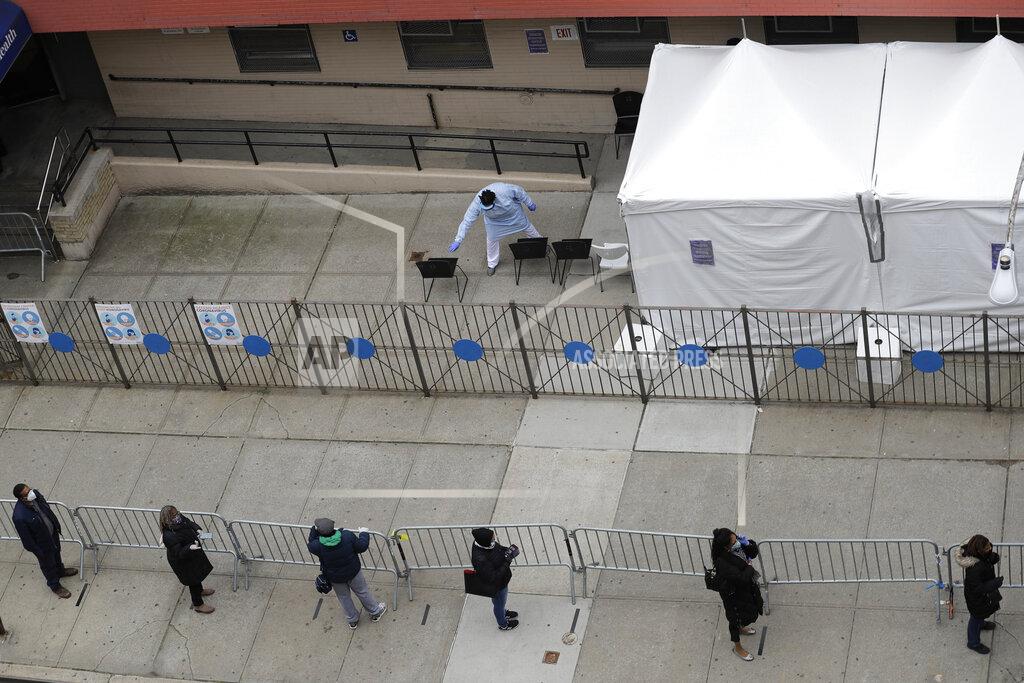 Seth Wenig People stand in line as they wait to get tested for COVID-19 at a just opened testing center in the Harlem section of New York, Monday, April 20, 2020. Hundreds of thousands of New Yorkers would need to be tested for the coronavirus daily before city officials could start to loosen restrictions that have shuttered most workplaces and forced residents to cover their faces in public, New York Mayor Bill de Blasio said Monday. (AP Photo/Seth Wenig)