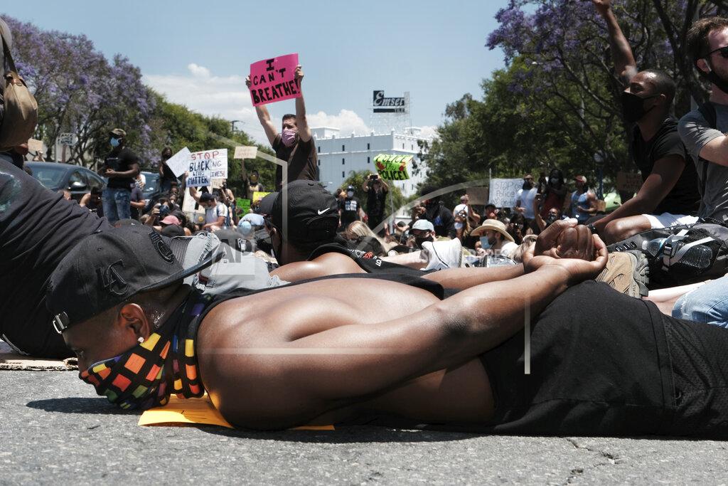 Richard Vogel Devion Coleman joins LGBTQ community members and Black Lives Matter protesters as they lay on the street with their hands on their backs in West Hollywood, Calif. on Wednesday, June 3, 2020, over the death of George Floyd, a black man who died in police custody in Minneapolis on Memorial Day. (AP Photo/Richard Vogel)