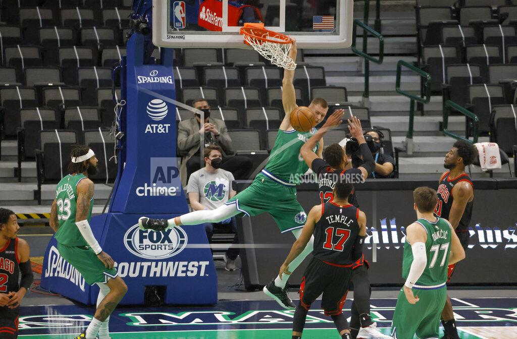 Ron Jenkins Dallas Mavericks forward Kristaps Porzingis (6) scores over Chicago Bulls center Daniel Gafford (12) during the first half of an NBA basketball game, Sunday, Jan. 17, 2021, in Dallas. (AP Photo/Ron Jenkins)
