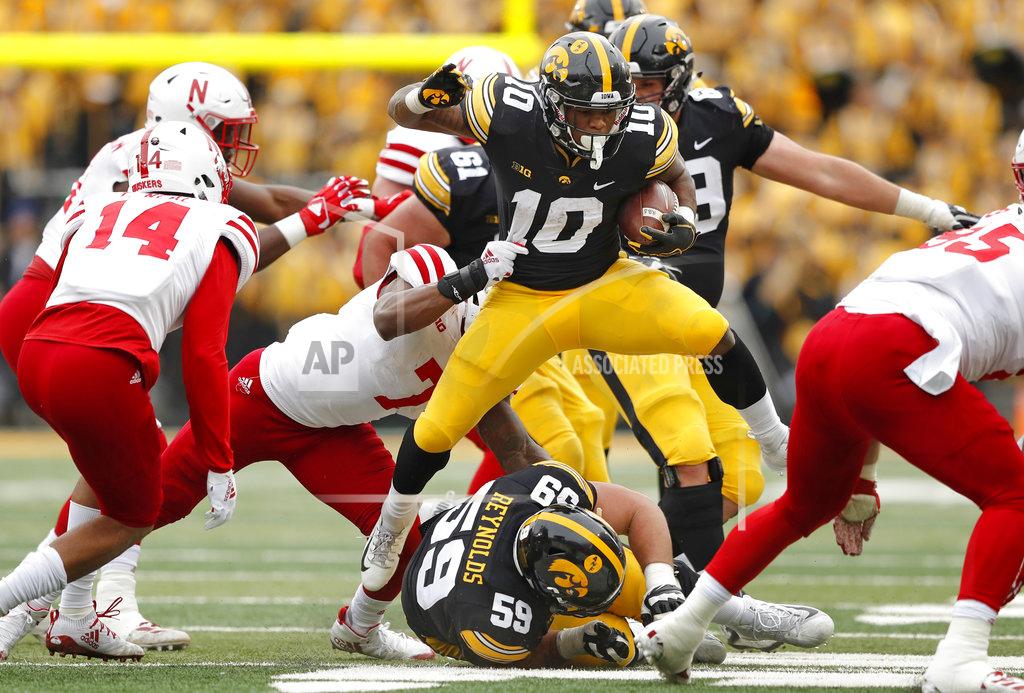 Charlie Neibergall Iowa running back Mekhi Sargent (10) tries to break a tackle by Nebraska linebacker Mohamed Barry (7) during the first half of an NCAA college football game, Friday, Nov. 23, 2018, in Iowa City, Iowa. Iowa won 31-28. (AP Photo/Charlie Neibergall)
