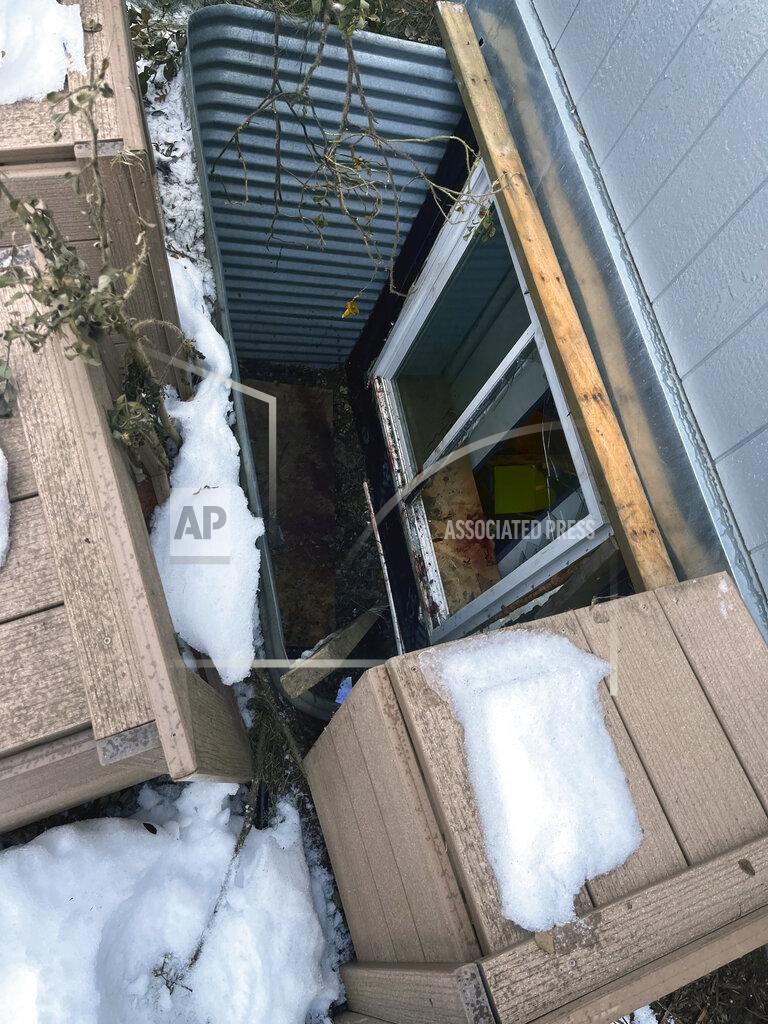 Capt. Josh Thompson In this image provided by Central Emergency Services for the Kenai Peninsula Borough, a window well is shown Sunday, Nov. 20, 2022, through which a moose fell into a home in Soldotna, Alaska. The moose was tranquilized and removed from the house on a stretcher, revived and set free back into the wild. (Capt. Josh Thompson/Central Emergency Services via AP)