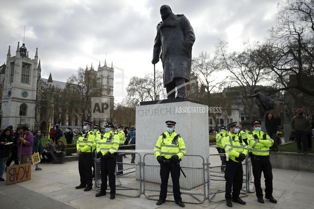 Matt Dunham Police stand guard around the statue of wartime prime minister Winston Churchill in Parliament Square during a 'Kill the Bill' protest in London, Saturday, April 3, 2021. The demonstration is against the contentious Police, Crime, Sentencing and Courts Bill, which is currently going through Parliament and would give police stronger powers to restrict protests. The statue had been defaced during anti-racism protests last year. (AP Photo/Matt Dunham)