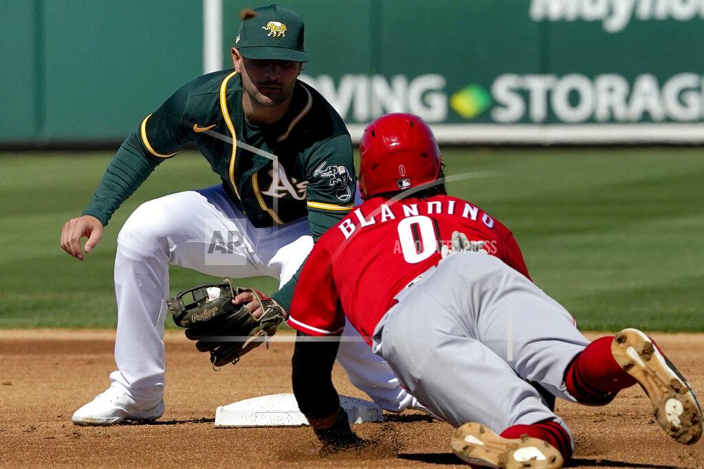 Matt York Oakland Athletics' Pete Kozma tags out Cincinnati Reds Alex Blandino (0) on a steal attempt during the first inning of a spring training baseball game, Monday, March 1, 2021, in Mesa, Ariz. (AP Photo/Matt York)