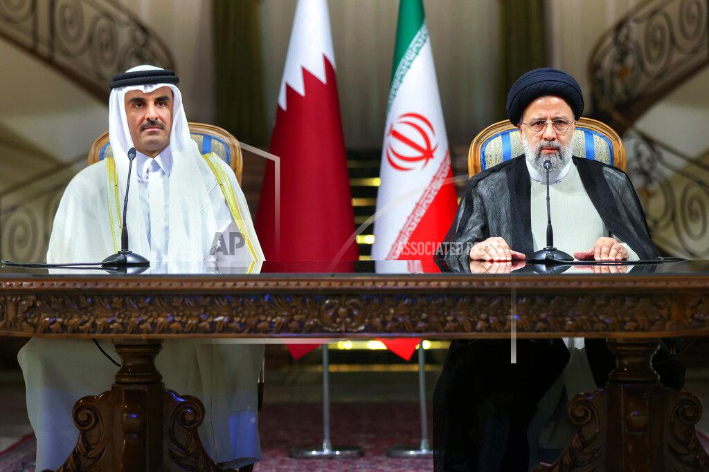 Uncredited In this photo released by the official website of the office of the Iranian Presidency, President Ebrahim Raisi, right, and Qatari Emir Sheikh Tamim bin Hamad Al Thani sit during their joint press briefing at the Saadabad Palace in Tehran, Iran, Thursday, May 12, 2022. Qatar's emir arrived in Tehran for talks with the Iranian president as efforts to save Tehran's tattered nuclear deal with world powers hit a deadlock. (Iranian Presidency Office via AP)