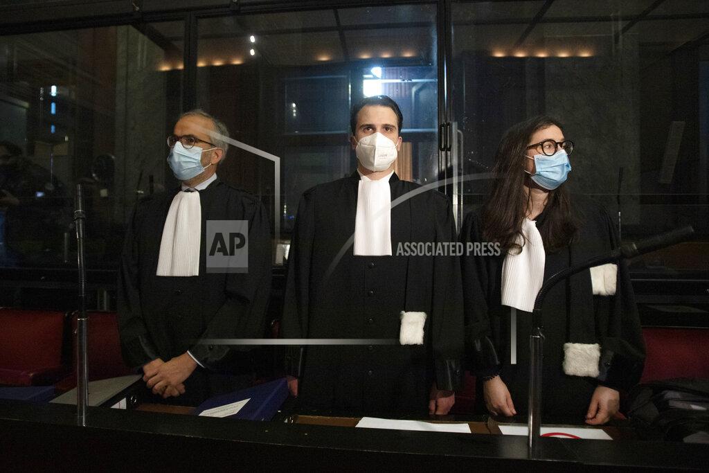 Virginia Mayo Lawyers for AstraZeneca Clemence Van Muylder, right, and Hakim Boularbah, left, wait for the start of a hearing, European Commission vs AstraZeneca, at the main courthouse in Brussels, Wednesday, May 26, 2021. The European Union took on vaccine producer AstraZeneca in a Brussels court on Wednesday with the urgent demand that the company needs to make an immediate delivery of COVID-19 shots the 27-nation bloc insists were already due. (AP Photo/Virginia Mayo)