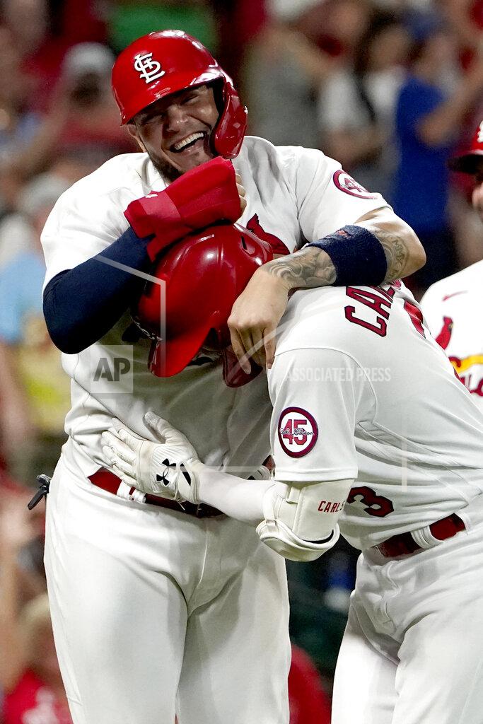 Jeff Roberson St. Louis Cardinals' Yadier Molina, top, congratulates teammate Dylan Carlson on his grand slam during the eighth inning of a baseball game against the San Diego Padres Friday, Sept. 17, 2021, in St. Louis. (AP Photo/Jeff Roberson)