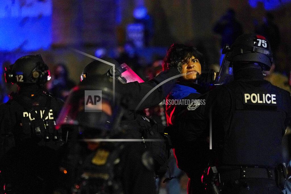 Portland police detain a man during protests, Saturday, Sept. 26, 2020, in Portland. The protests, which began over the killing of George Floyd, often result frequent clashes between protesters and law enforcement. (AP Photo/John Locher)