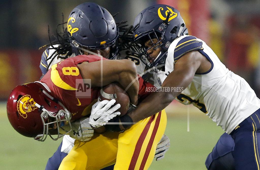 Alex Gallardo Southern California wide receiver Amon-Ra St. Brown, left, is stopped by California linebacker Alex Funches, center, and cornerback Elijah Hicks, right, after a reception during the first half of an NCAA college football game in Los Angeles, Saturday, Nov. 10, 2018. (AP Photo/Alex Gallardo)