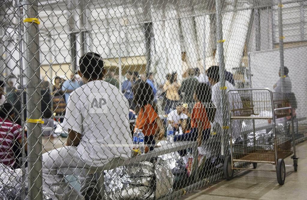 Uncredited FILE - In this June 17, 2018, file photo provided by U.S. Customs and Border Protection, people who've been taken into custody related to illegal entry cases into the United States sit in one of the cages at a facility in McAllen, Texas. For the opening salvo of his presidency, few expected Joe Biden to be so far-reaching on immigration. A raft of executive orders issued Wednesday, Jan. 20, 2021, undoes many of his predecessor's hallmark initiatives. (U.S. Customs and Border Protection's Rio Grande Valley Sector via AP, File)
