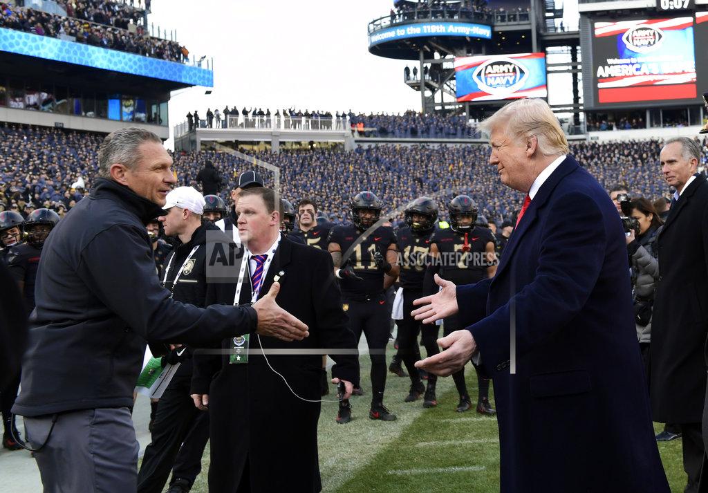 Susan Walsh President Donald Trump, right, greets Army coach Jeff Monken before the Army-Navy NCAA college football game in Philadelphia, Saturday, Dec. 8, 2018. (AP Photo/Susan Walsh)