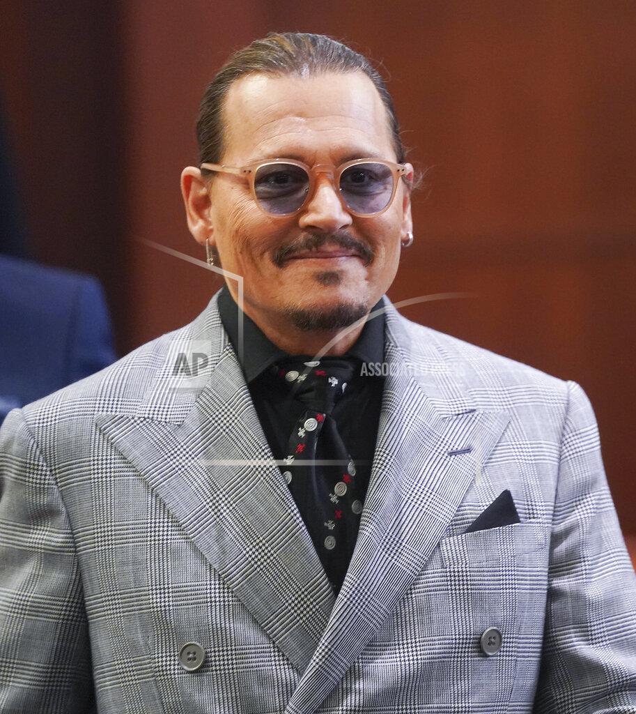 Shaw Thew Actor Johhny Depp returns from a break at the Fairfax County Circuit Courthouse in Fairfax, Va., Thursday, May 19, 2022. Actor Johnny Depp sued his ex-wife Amber Heard for libel in Fairfax County Circuit Court after she wrote an op-ed piece in The Washington Post in 2018 referring to herself as a "public figure representing domestic abuse." (Shawn Thew/Pool Photo via AP)