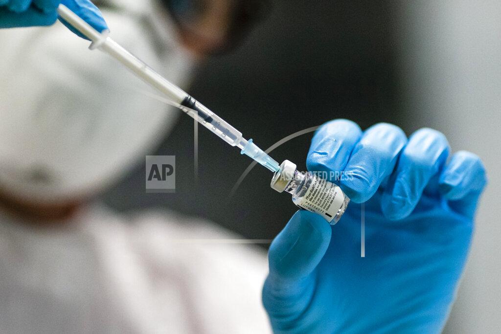 Frank Molter An employee of a vaccination centre draws the vaccine from a glass ampoule in Kiel, Germany, Monday, Jan. 4, 2021. On Monday vaccinations against the coronavirus have started in the German state of Schleswig-Holstein. (Frank Molter/dpa via AP)