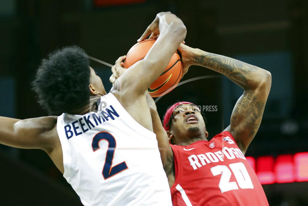 Andrew Shurtleff Radford forward Dravon Mangum (20) is fouled by Virginia guard Reece Beekman (2) during an NCAA college basketball game in Charlottesville, Va., Friday, Nov. 12, 2021. (AP Photo/Andrew Shurtleff)
