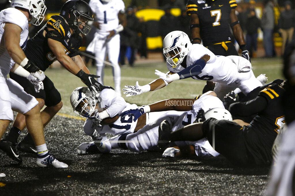 Brian Blanco Georgia Southern running back Wesley Kennedy III (12) falls into the end zone for a touchdown during the first half of the team's NCAA college football game against Appalachian State on Thursday, Oct. 31, 2019, in Boone, NC. (AP Photo/Brian Blanco)