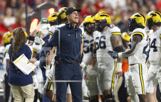 Michigan coach Jim Harbaugh yells to officials during a timeout in the first half of an NCAA college football game against Nebraska on Saturday, Oct. 9, 2021, in Lincoln, Neb. (AP Photo/Rebecca S. Gratz)
