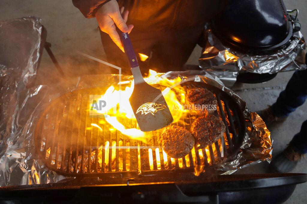 Julio Cortez Fans tailgate in the parking lot before an NFL football game between the Baltimore Ravens and the San Francisco 49ers, Sunday, Dec. 1, 2019, in Baltimore, Md. (AP Photo/Julio Cortez)