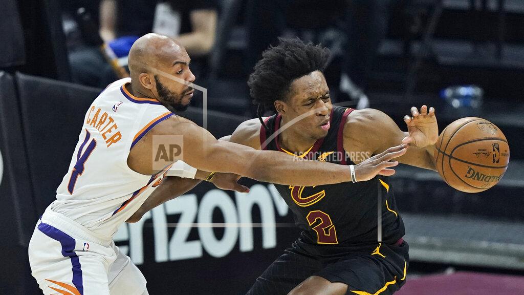 Tony Dejak Phoenix Suns' Jevon Carter, left, fouls Cleveland Cavaliers' Collin Sexton in the first half of an NBA basketball game, Tuesday, May 4, 2021, in Cleveland. (AP Photo/Tony Dejak)
