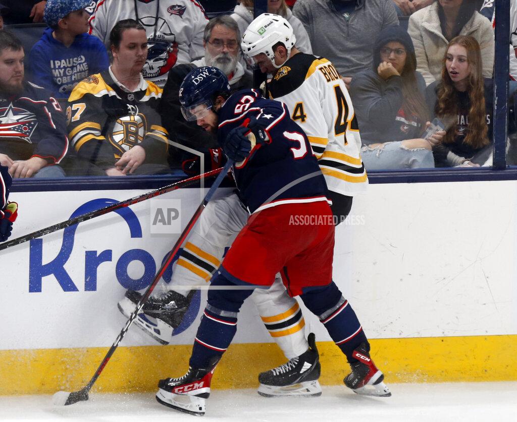 Paul Vernon Columbus Blue Jackets forward Emil Bemstrom, left, checks Boston Bruins defenseman Josh Brown during the third period of an NHL hockey game in Columbus, Ohio, Monday, April 4, 2022. (AP Photo/Paul Vernon)