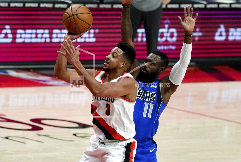 Steve Dykes Portland Trail Blazers guard CJ McCollum, left, is fouled by Dallas Mavericks forward Tim Hardaway Jr. during the first half of an NBA basketball game in Portland, Ore., Friday, March 19, 2021. AP Photo/Steve Dykes)