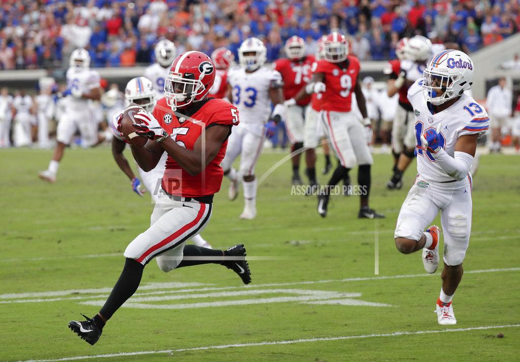 John Raoux Georgia wide receiver Terry Godwin (5) catches a 24-yard pass for a touchdown as he gets past Florida safety Donovan Stiner (13) during the second half of an NCAA college football game Saturday, Oct. 27, 2018, in Jacksonville, Fla. (AP Photo/John Raoux)