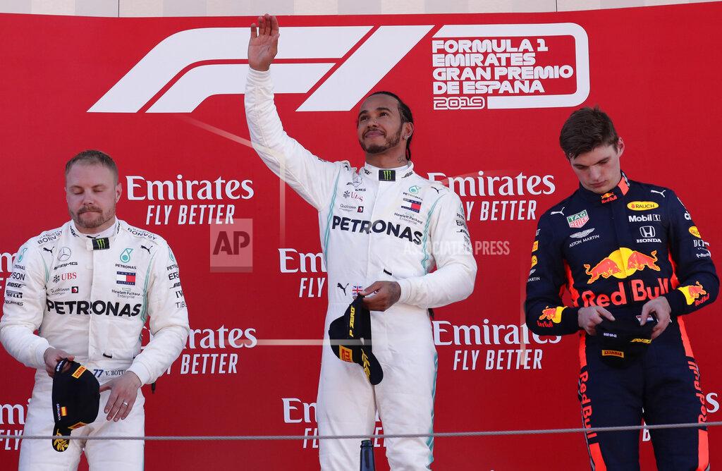 Manu Fernandez Mercedes driver Lewis Hamilton of Britain, center, celebrates on the podium after winning the Spanish Formula One race, flanked by second place Mercedes driver Valtteri Bottas of Finland, left and third place Red Bull driver Max Verstappen of the Netherland's, at the Barcelona Catalunya racetrack in Montmelo, just outside Barcelona, Spain, Sunday, May 12, 2019. (AP Photo/Manu Fernandez)