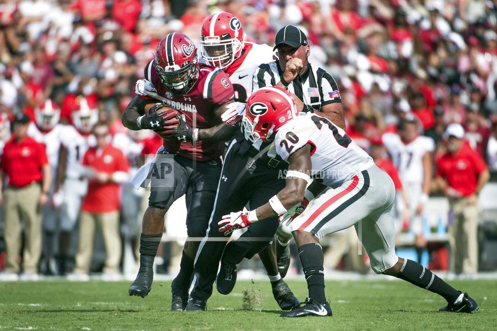 Sean Rayford South Carolina wide receiver Deebo Samuel, left, runs with the ball against Georgia defensive back J.R. Reed (20) and Deandre Baker during the first half of an NCAA college football game Saturday, Sept. 8, 2018, in Columbia, S.C. (AP Photo/Sean Rayford)
