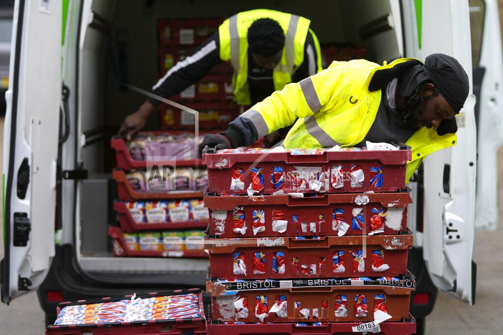 Frank Augstein Volunteers from the charity 'The Felix Project' unload bread at their storage hub in London, Wednesday, May 4, 2022. Across Britain, food banks and community food hubs that helped struggling families, older people and the homeless during the pandemic are now seeing soaring demand. The cost of food and fuel in the U.K. has risen sharply since late last year, with inflation reaching the highest level in 40 years. (AP Photo/Frank Augstein)