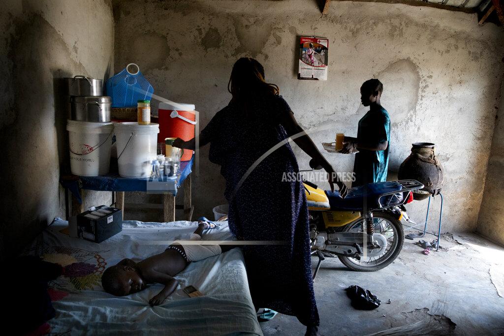 Adrienne Surprenant Paska Itwari Beda, the young mother of five children, prepares her husband's family reunion at their Juba, South Sudan home, Saturday, May 29, 2021. Even before the pandemic hit, South Sudanese women were accustomed to building lives on the edge of uncertainty. But COVID-19 is shaking that fragile foundation. The country is just a decade old and one of the world's most difficult places to raise children. (AP Photo/Adrienne Surprenant)