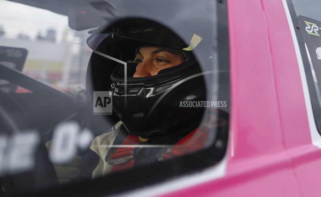 Natacha Pisarenko Vitarti Girl's Team driver Rocio Migliore sits in her car before the team's first race at the Oscar y Juan Galvez track in Buenos Aires, Argentina, Sunday, April 4, 2021. The Vitarti Girl's Team is the first entirely female team to take part in a national racing competition in Argentina. (AP Photo/Natacha Pisarenko)
