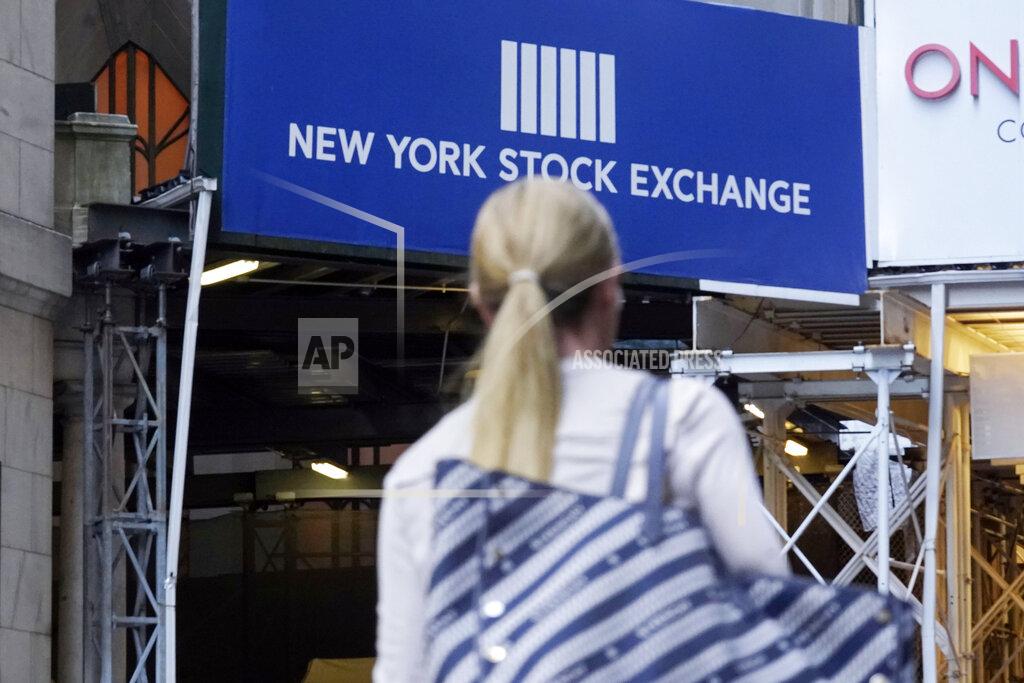 A woman passes an entrance of the New York Stock Exchange, Wednesday, June 16, 2021. Stocks are opening higher on Wall Street, continuing an upturn this week that has brought the S&P 500 back to the record high level it reached a week and a half ago. The benchmark index was up 0.6% in the early going Thursday, June 24. (AP Photo/Richard Drew)