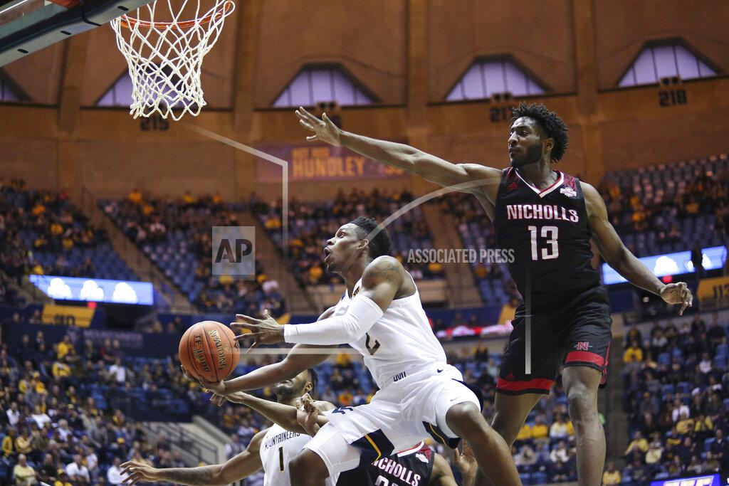 Kathleen Batten West Virginia guard Brandon Knapper (2) is defended by Nicholls State guard Andre Jones (13) as he goes to make a shot during the second half of an NCAA college basketball game Saturday, Dec. 14, 2019, in Morgantown, W.Va. (AP Photo/Kathleen Batten)