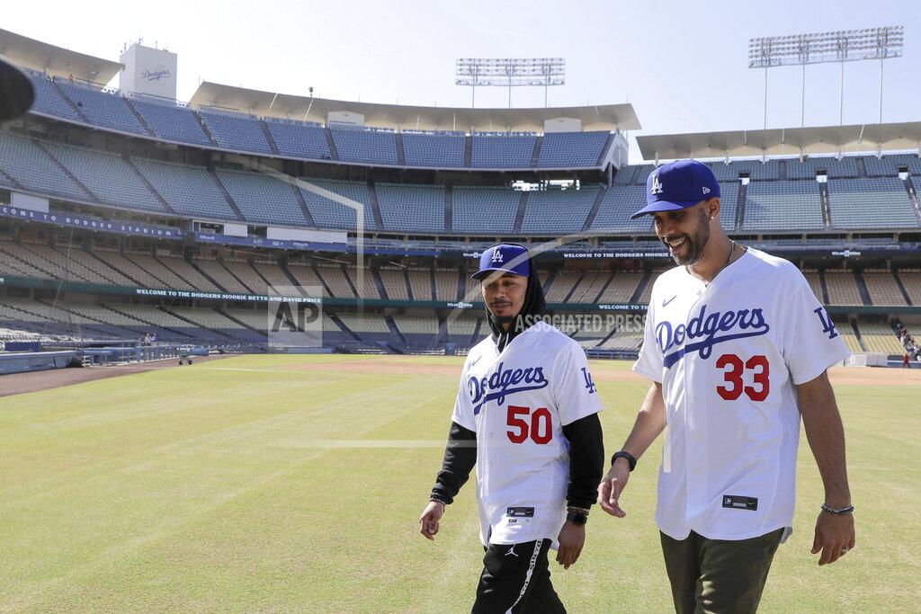 New Los Angeles Dodgers players David Price, right, and Mookie Betts walk after a news conference to announce their acquisition at Dodger Stadium in Los Angeles, Wednesday, Feb. 12, 2020. (AP Photo/Chris Carlson)