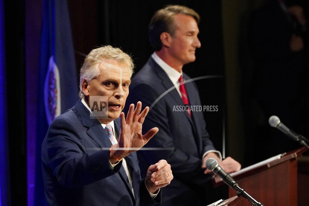 Steve Helber Democratic gubernatorial candidate and former governor Terry McAuliffe, left, gestures as his Republican challenger, Glenn Youngkin, looks on during a debate at the Appalachian School of Law in Grundy, Va., Thursday, Sept. 16, 2021. (AP Photo/Steve Helber)