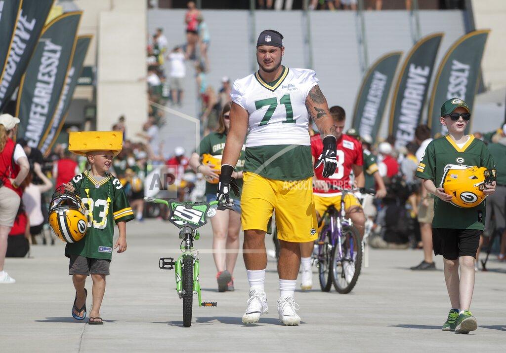 Morry Gash Green Bay Packers' Anthony Coyle walks a bike to NFL football training camp Thursday, July 25, 2019, in Green Bay, Wis. (AP Photo/Morry Gash)