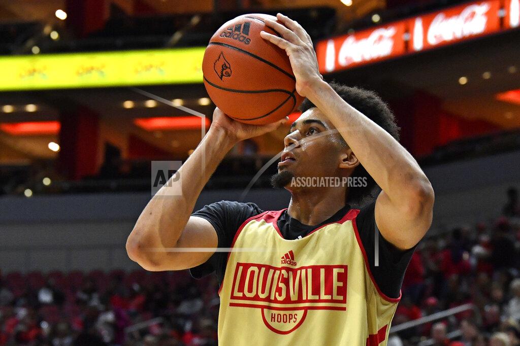 FILE - In this Oct. 12, 2019, file photo, Louisville forward Jordan Nwora warms up before the start of an NCAA college basketball practice in Louisville, Ky. Louisville is back in the national championship conversation after the basketball program was knocked on its heels amid the fallout of embarrassing scandals, including the school’s missteps that were discovered in a federal investigation into college basketball and escorts performing in players’ dorm. (AP Photo/Timothy D. Easley, File)