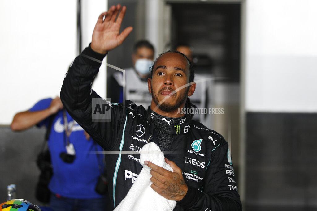 Hamad I Mohammed Mercedes driver Lewis Hamilton of Britain waves after qualifying session qualifying session in Lusail, Qatar, Saturday, Nov. 20, 2021 ahead of the Qatar Formula One Grand Prix. (Hamad I Mohammed, Pool via AP)
