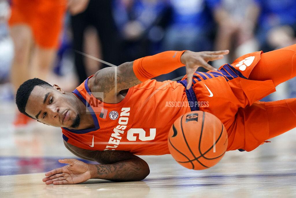 Gerry Broome Clemson guard Al-Amir Dawes (2) falls to the floor while chasing the ball during the first half of an NCAA college basketball game against Duke in Durham, N.C., Tuesday, Jan. 25, 2022. (AP Photo/Gerry Broome)