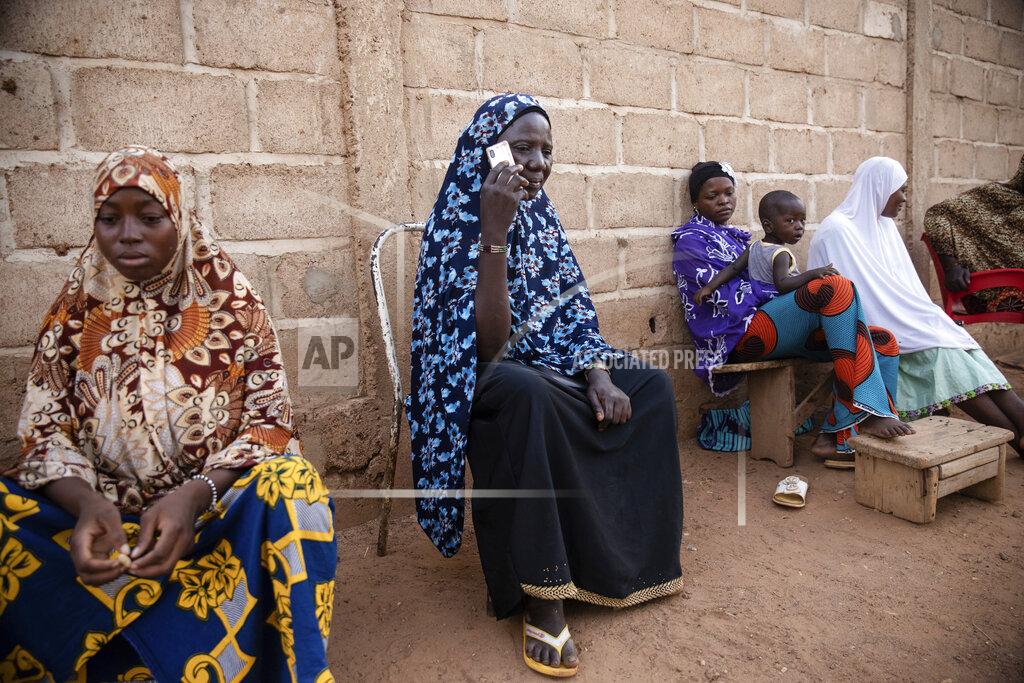 Sophie Garcia Women listen to Mariama Sawadogo on Zama Radio, in Kaya, Burkina Faso, Monday, Oct. 25, 2021. Many guests and listeners in Burkina Faso call Sawadogo "aunty" as she gently guides them to the right answers and awards prizes such as soap and washing buckets. In the West African country of Burkina Faso, many feel the government has let them down during the pandemic. Tests, vaccines and messaging often miss many residents, despite a $200 million budget for virus-response efforts. In a region where women are responsible for family work and community relationships, they’ve stepped up to fill in gaps. (AP Photo/Sophie Garcia)